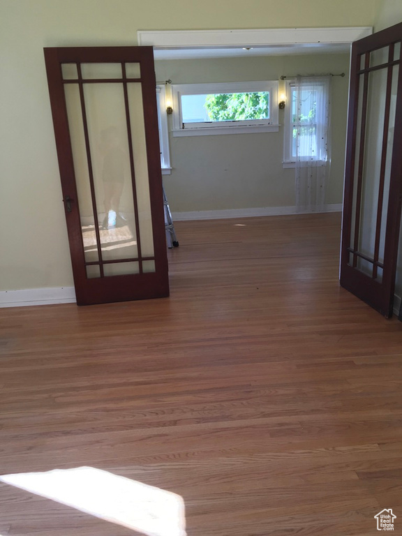 Spare room featuring dark hardwood / wood-style flooring and french doors