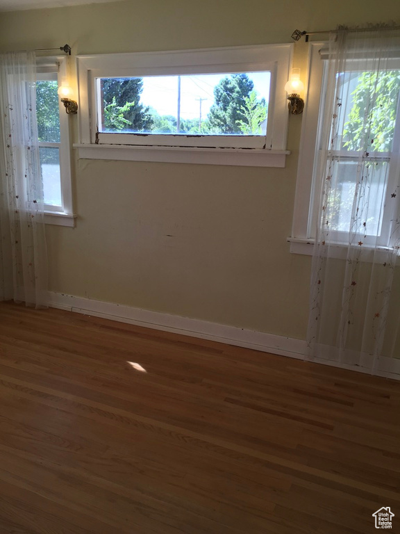 Unfurnished room with hardwood / wood-style floors