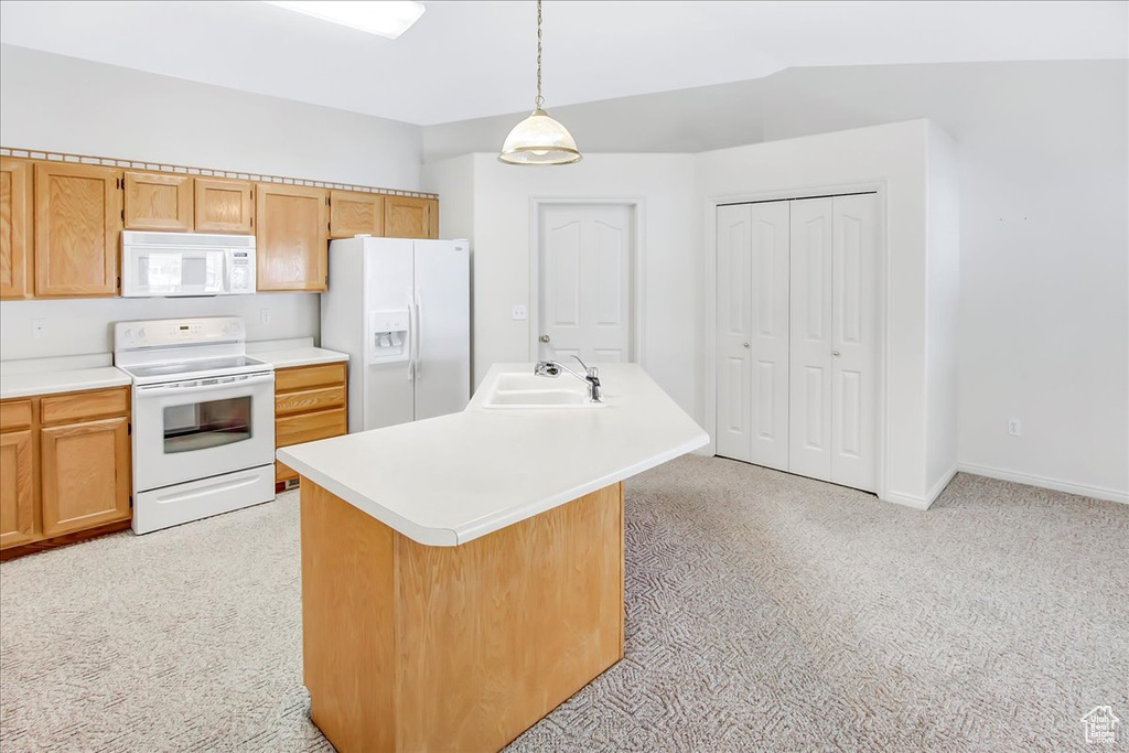 Kitchen with light carpet, sink, and white appliances