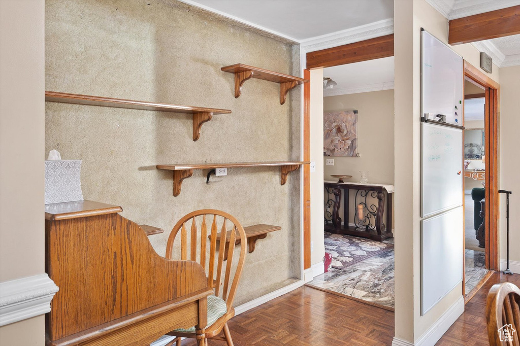 Dining space with ornamental molding and dark parquet floors