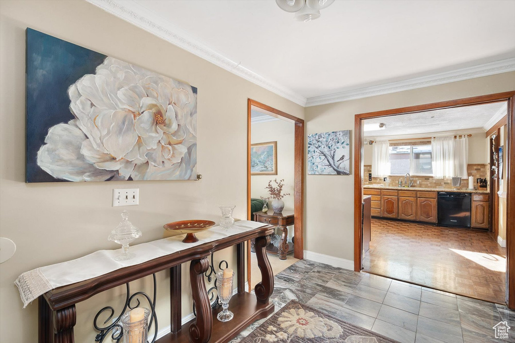 Hall with ornamental molding and light tile floors