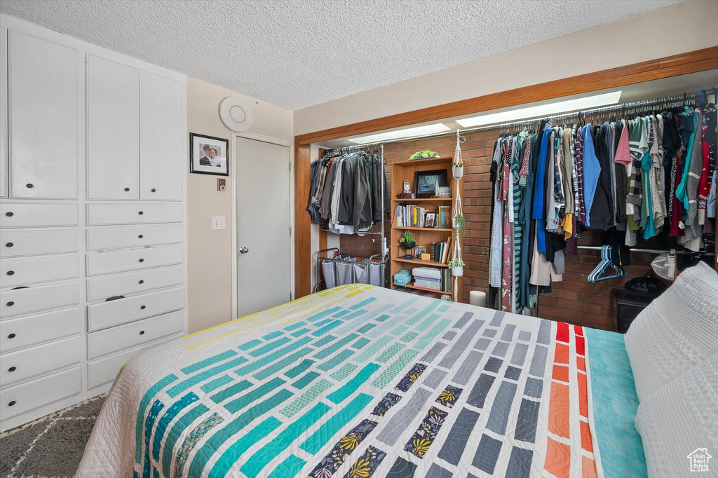 Bedroom featuring a closet and a textured ceiling