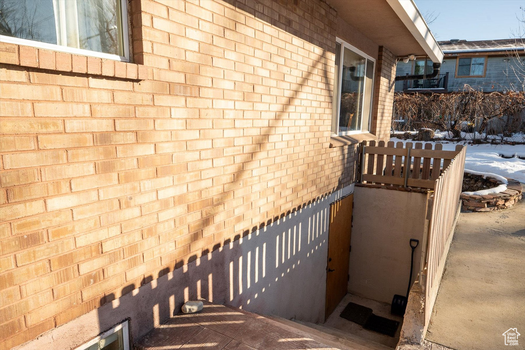 Staircase featuring brick wall