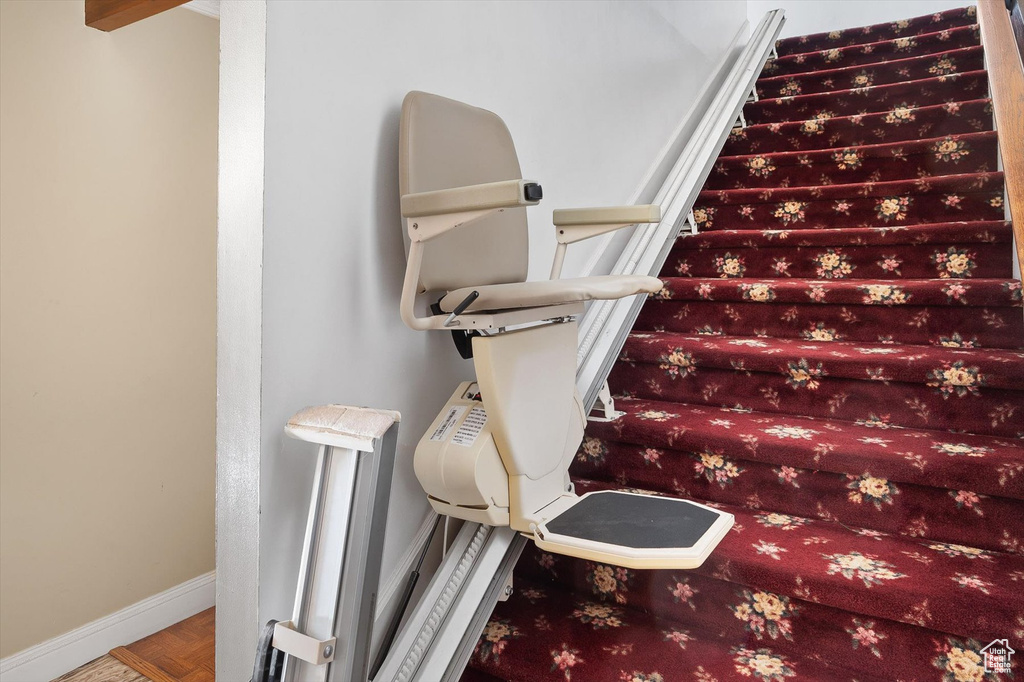 Stairs featuring parquet floors