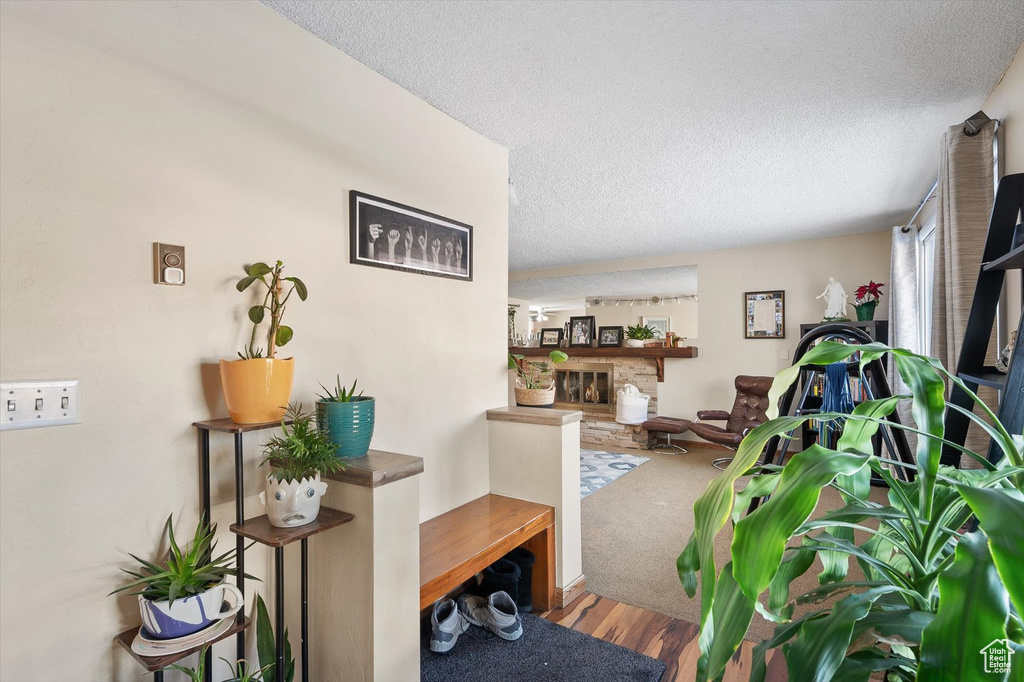 Living room with a textured ceiling and hardwood / wood-style floors