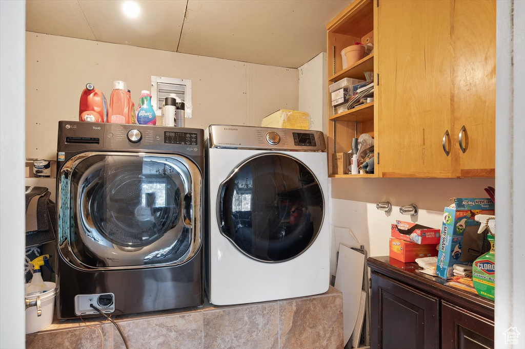 Laundry area with cabinets and washer and dryer