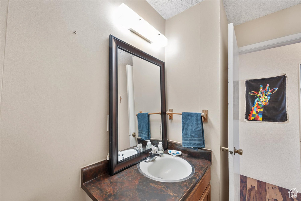 Bathroom featuring vanity and a textured ceiling