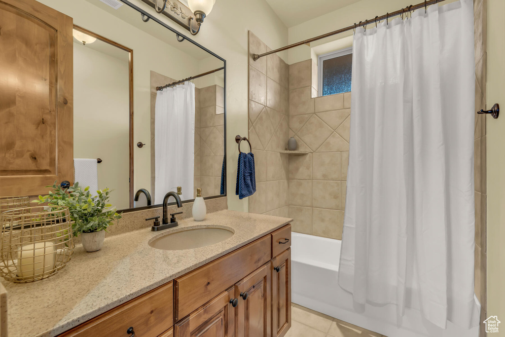 Bathroom with shower / bath combination with curtain, tile flooring, and vanity