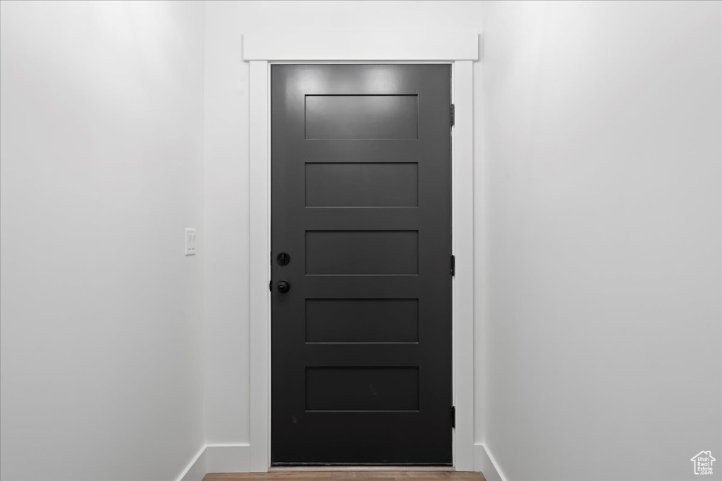 Doorway with hardwood / wood-style floors