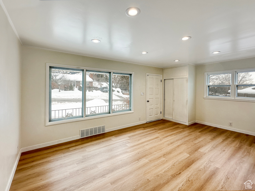 Spare room featuring plenty of natural light and light hardwood / wood-style flooring