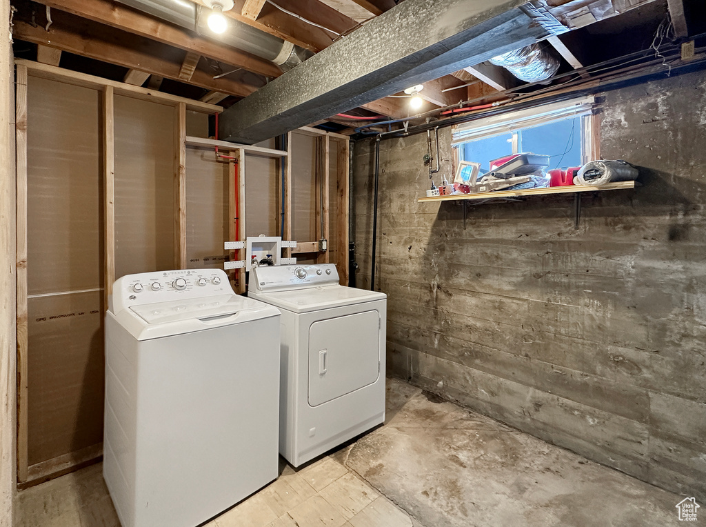Clothes washing area featuring washer hookup and washing machine and dryer