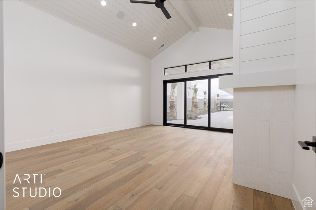 Empty room with light hardwood / wood-style floors, beamed ceiling, high vaulted ceiling, and ceiling fan