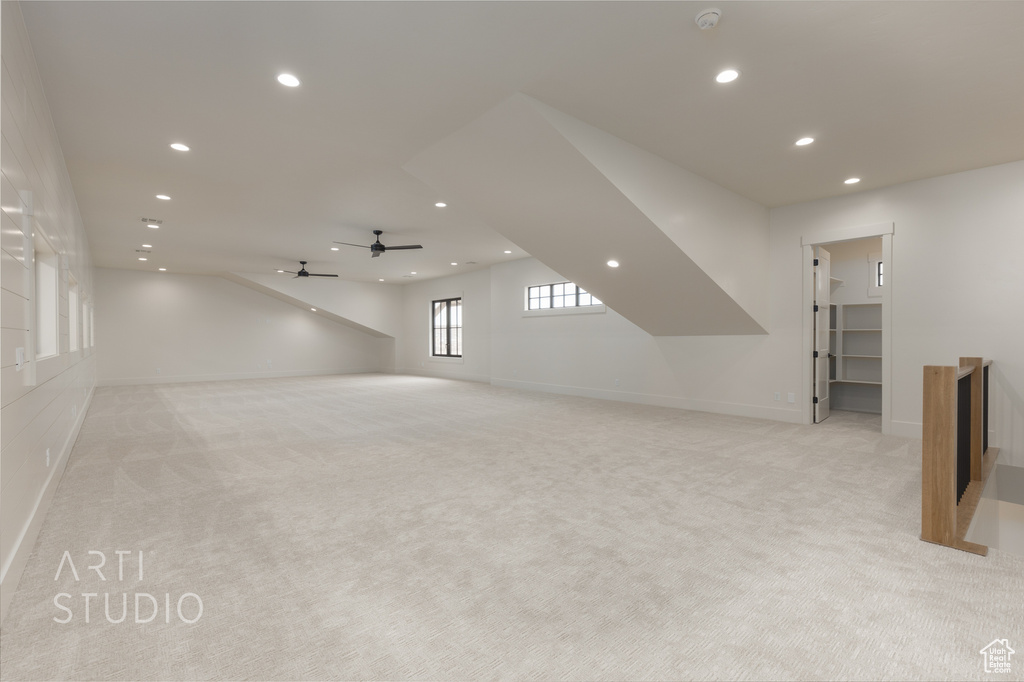 Bonus room featuring light carpet and ceiling fan