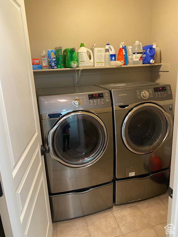 Laundry area featuring independent washer and dryer and light tile floors