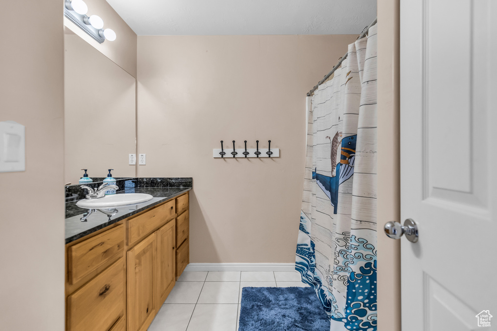 Bathroom featuring tile floors and vanity