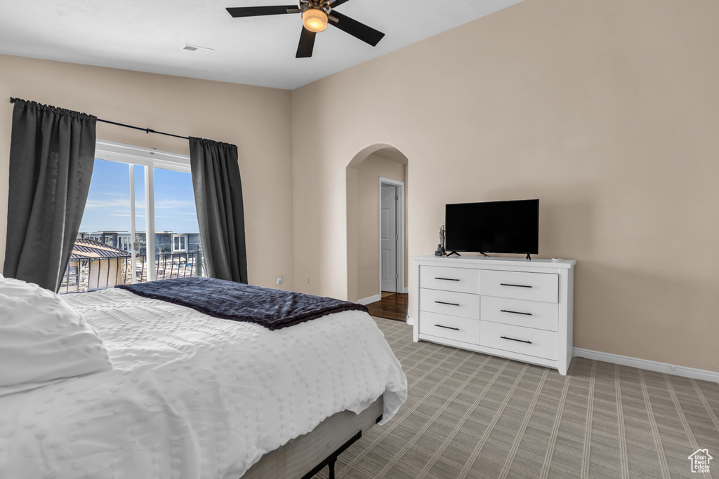 Bedroom featuring vaulted ceiling, access to exterior, and ceiling fan