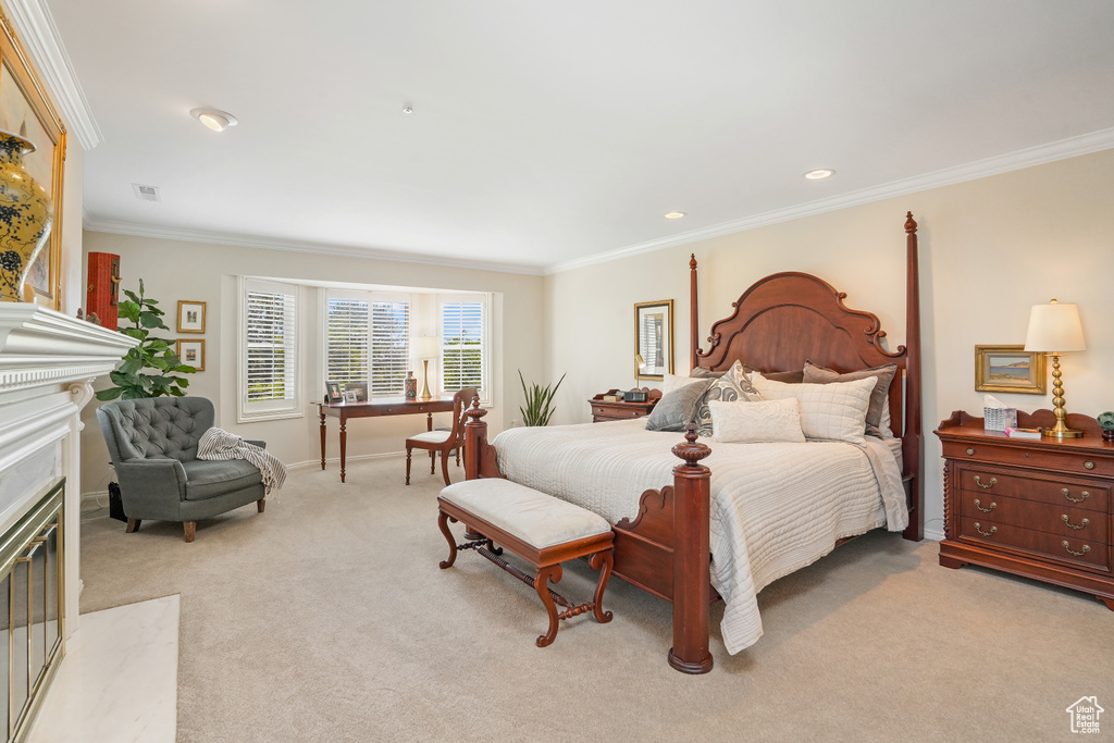 Carpeted bedroom featuring a high end fireplace and crown molding