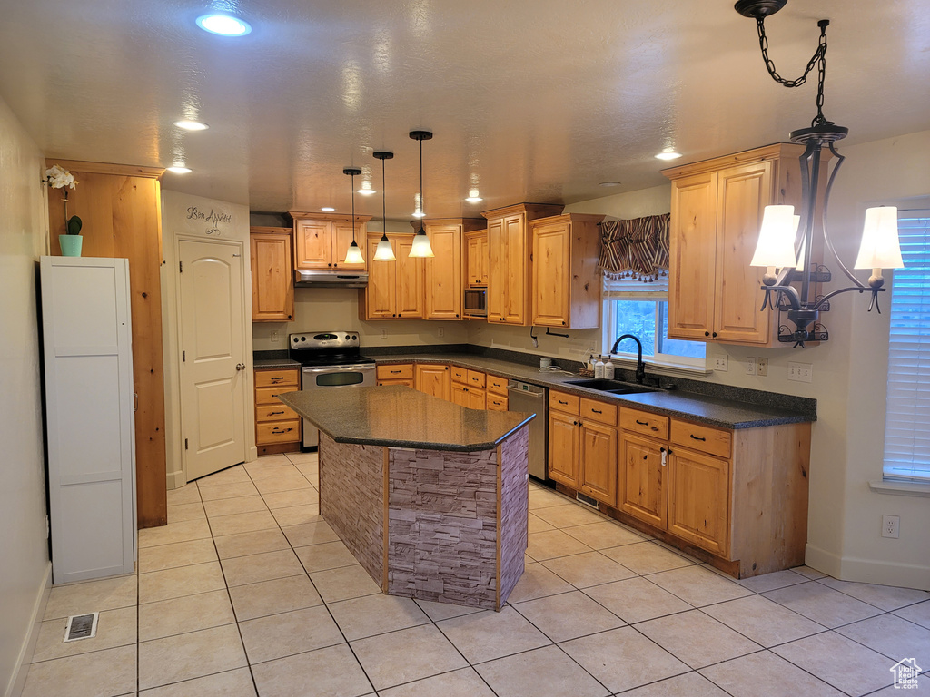 Kitchen featuring a kitchen island, a chandelier, light tile flooring, sink, and stainless steel appliances