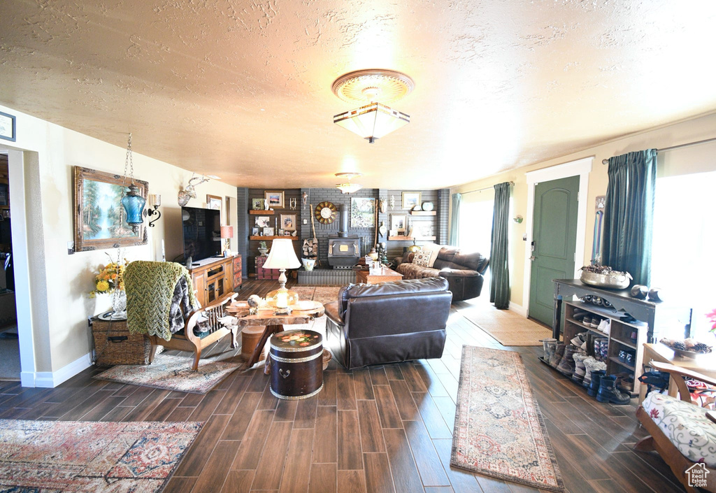 Living room with dark wood-type flooring and a textured ceiling