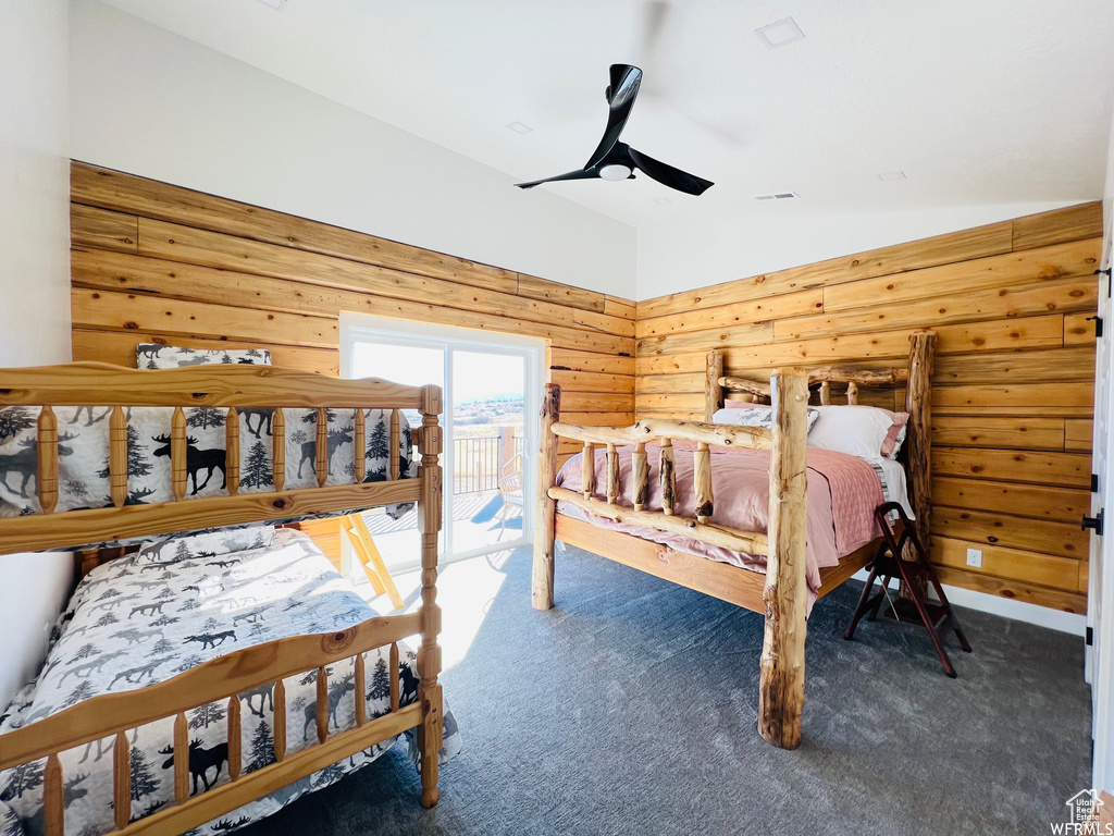 Bedroom with access to exterior, dark colored carpet, lofted ceiling, and ceiling fan