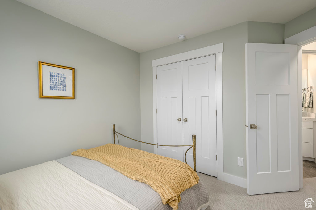 Carpeted bedroom featuring a closet