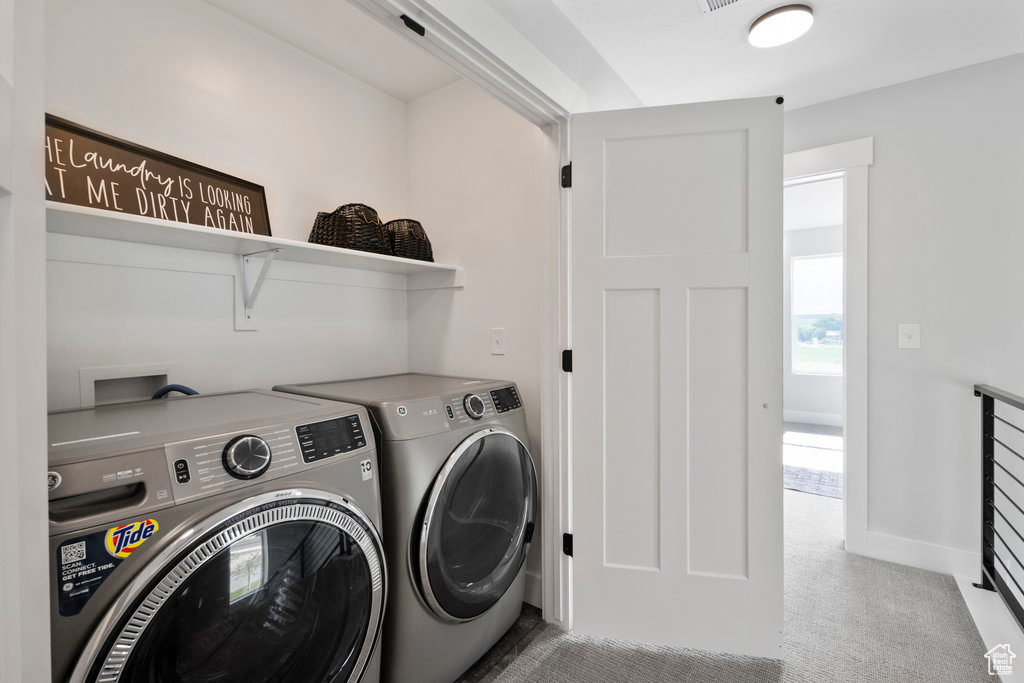 Clothes washing area featuring separate washer and dryer