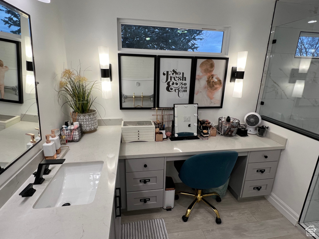 Office space featuring sink and built in desk