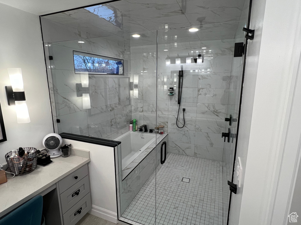 Bathroom featuring vanity and plus walk in shower