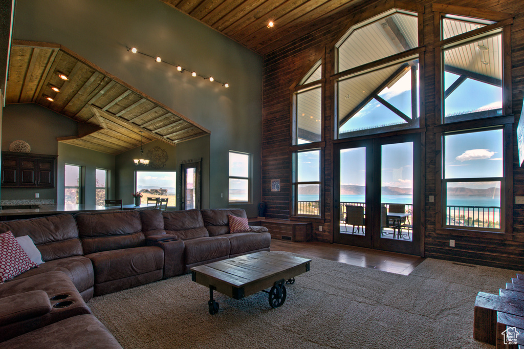 Living room with a wealth of natural light, wood ceiling, and high vaulted ceiling