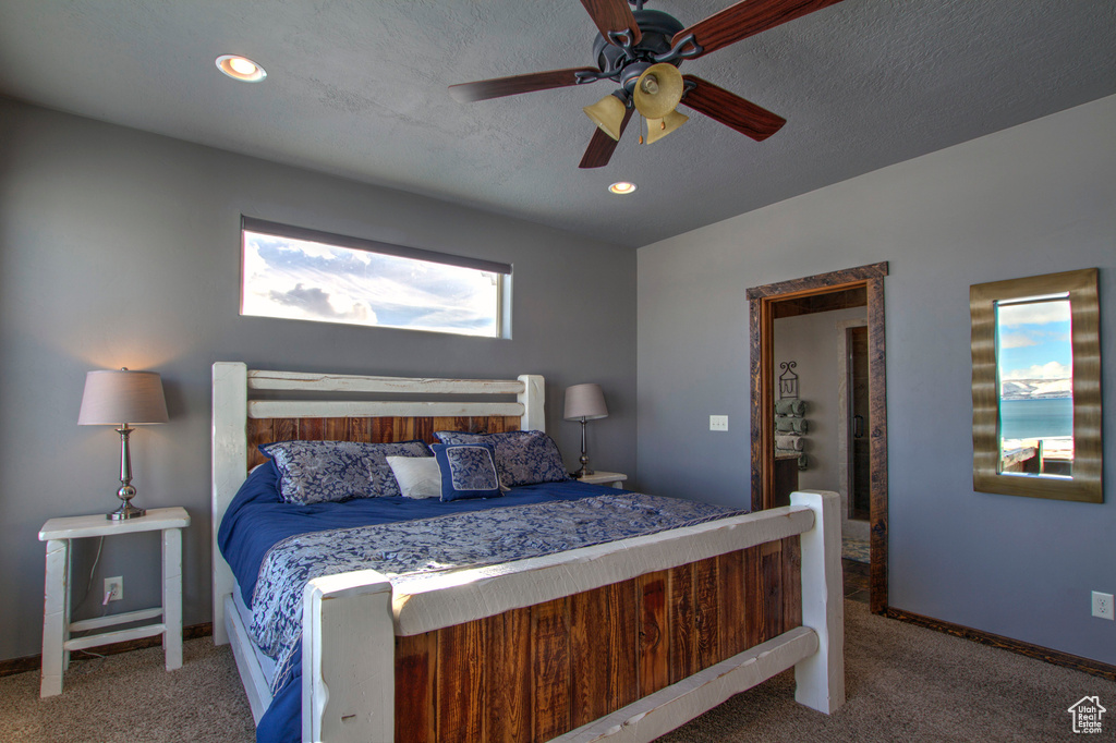 Bedroom featuring carpet floors, a textured ceiling, and ceiling fan