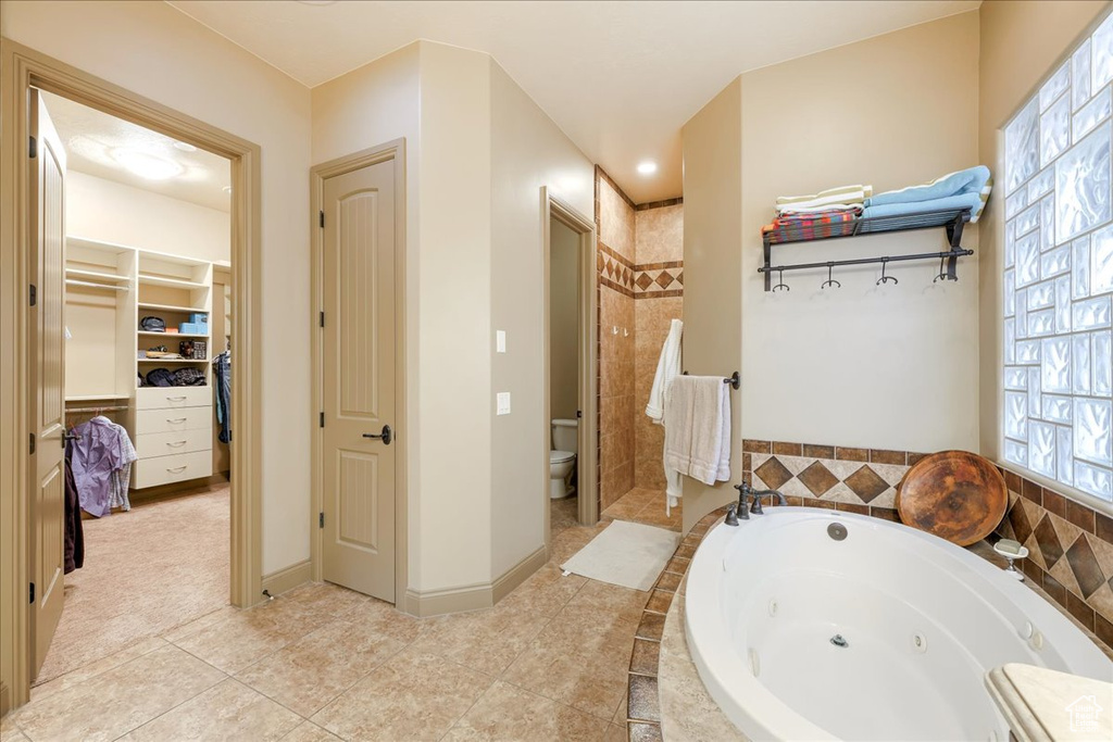 Full bathroom with toilet, vanity, separate shower and tub, and tile flooring