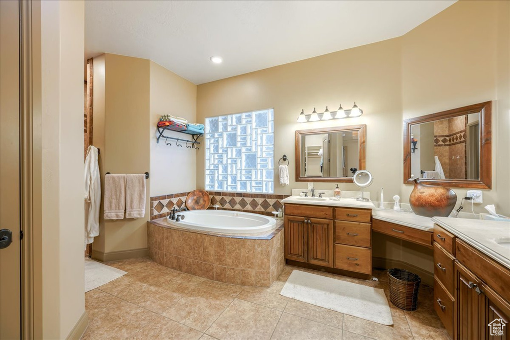Bathroom with tile floors, oversized vanity, and tiled bath