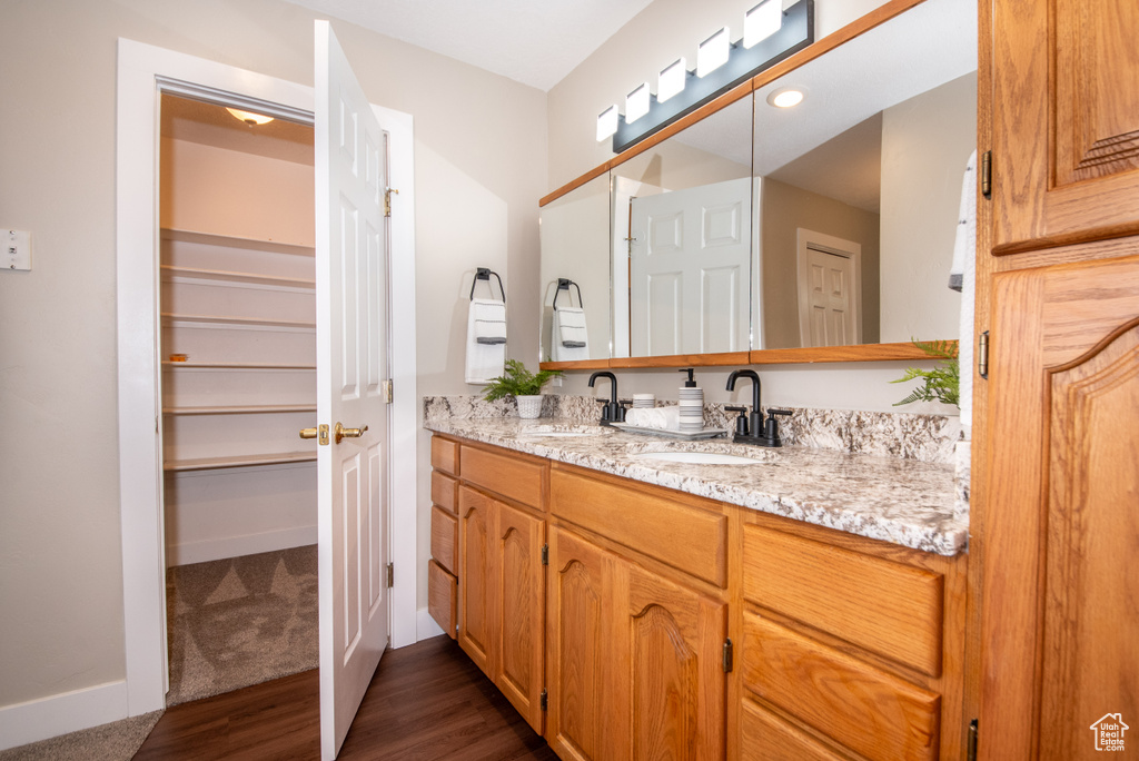 Bathroom with hardwood / wood-style flooring and oversized vanity