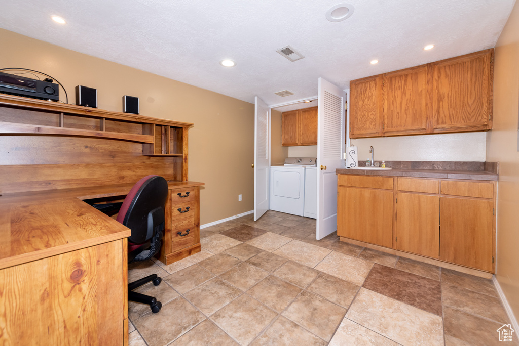 Office space featuring independent washer and dryer, light tile floors, and sink