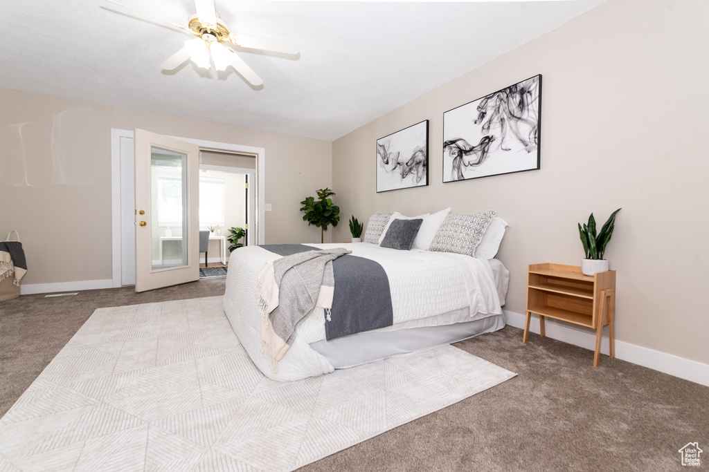 Bedroom with access to exterior, light colored carpet, and ceiling fan