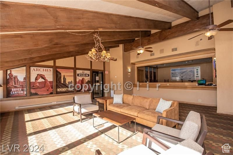 Unfurnished living room with ceiling fan with notable chandelier and lofted ceiling with beams