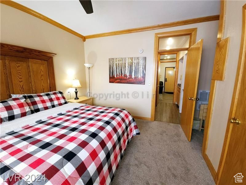 Bedroom featuring crown molding, hardwood / wood-style floors, and ceiling fan