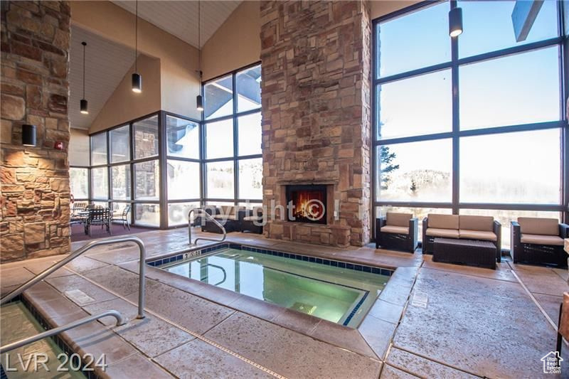 View of pool with a fireplace