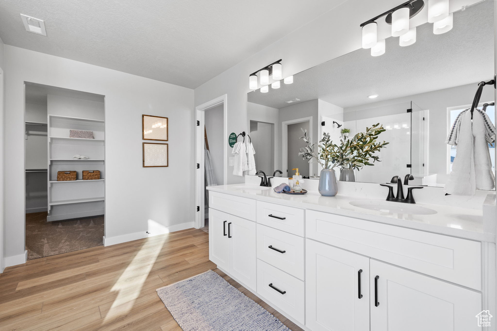 Bathroom featuring double vanity and hardwood / wood-style floors