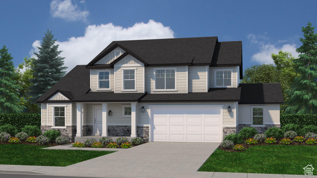 View of front facade featuring a garage and a front yard