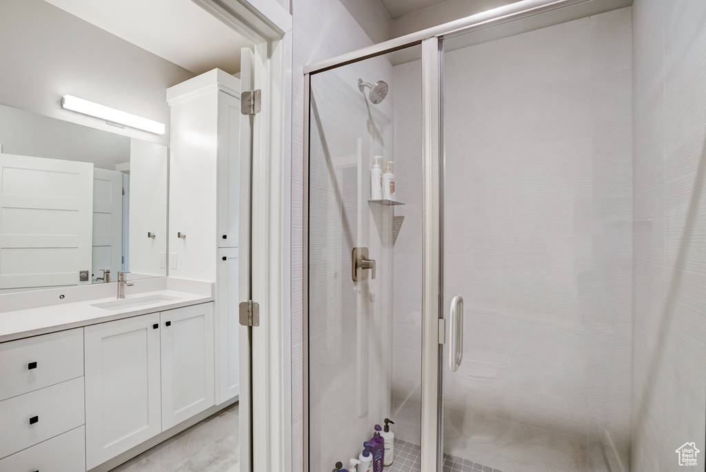 Bathroom featuring large vanity and walk in shower