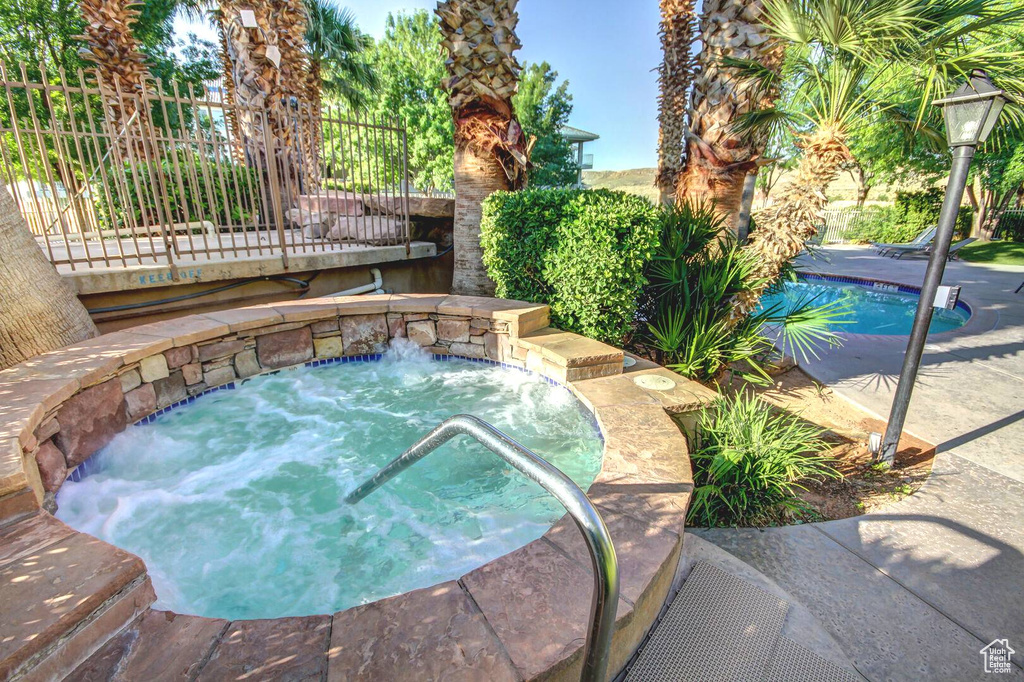 View of pool with an in ground hot tub