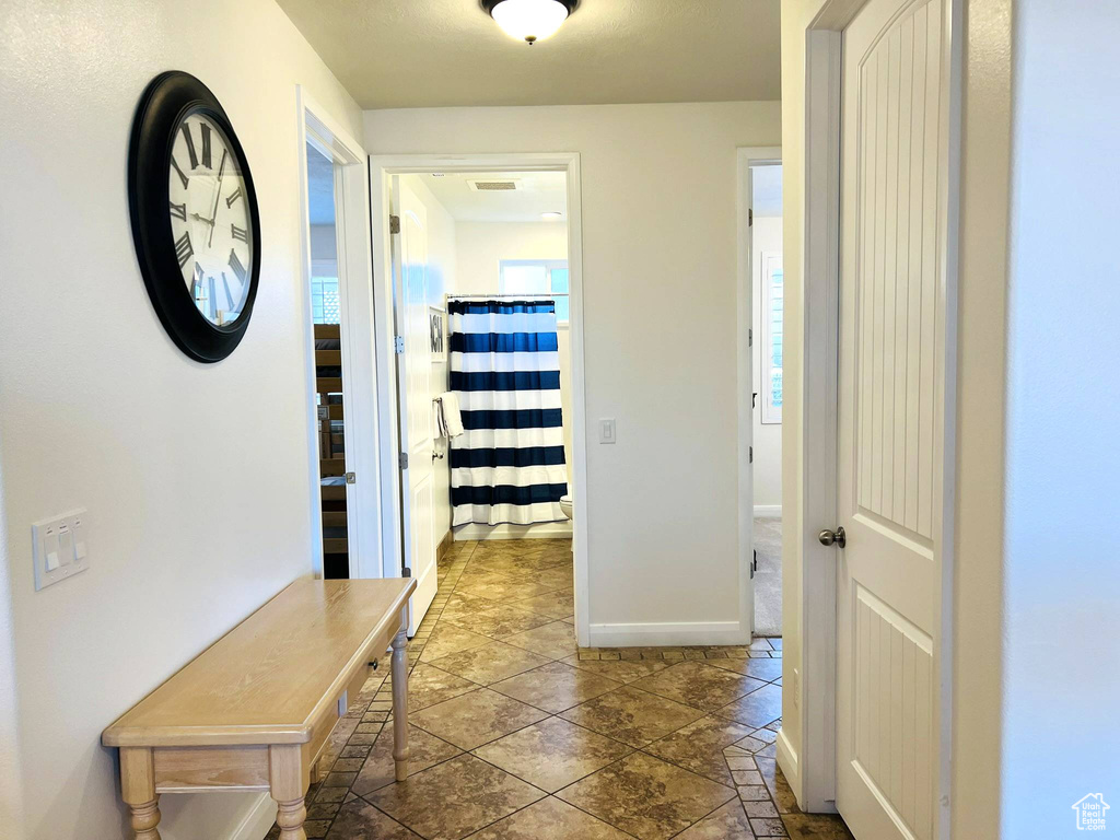 Hall with tile flooring