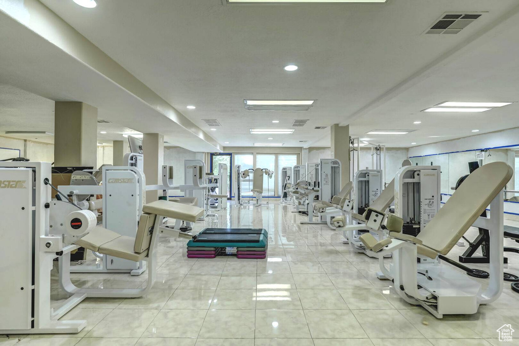 Workout area featuring light tile floors