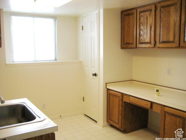 Kitchen with sink and light tile floors