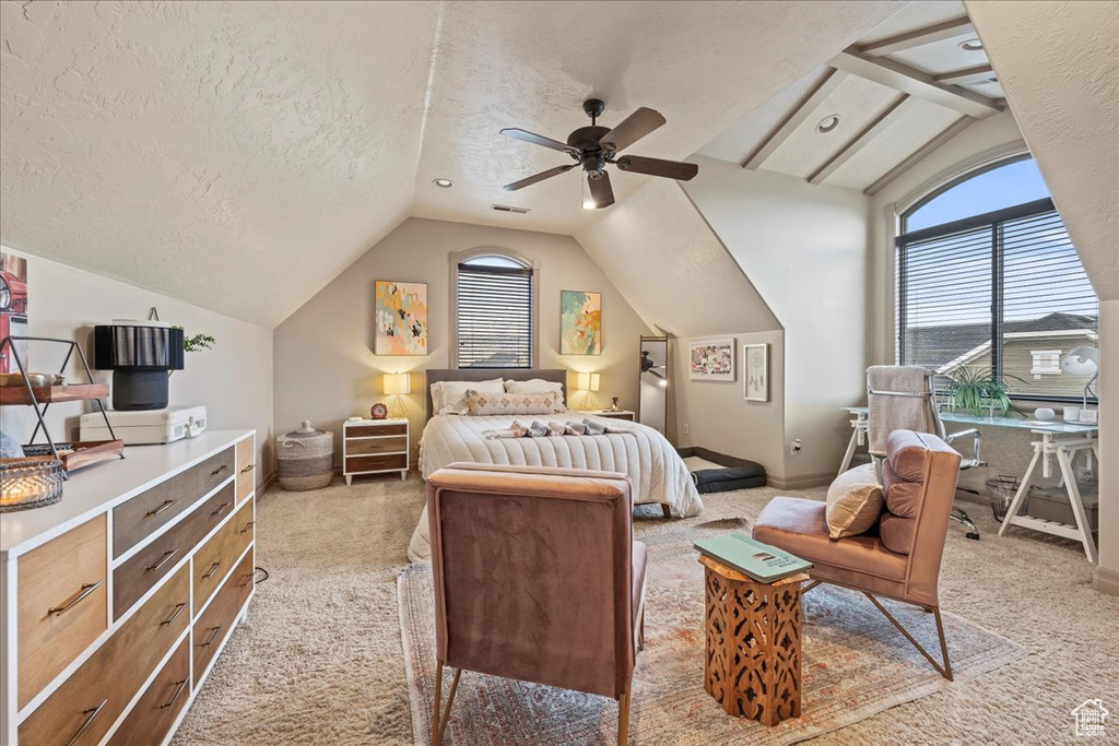 Carpeted bedroom featuring lofted ceiling with beams, a textured ceiling, and ceiling fan