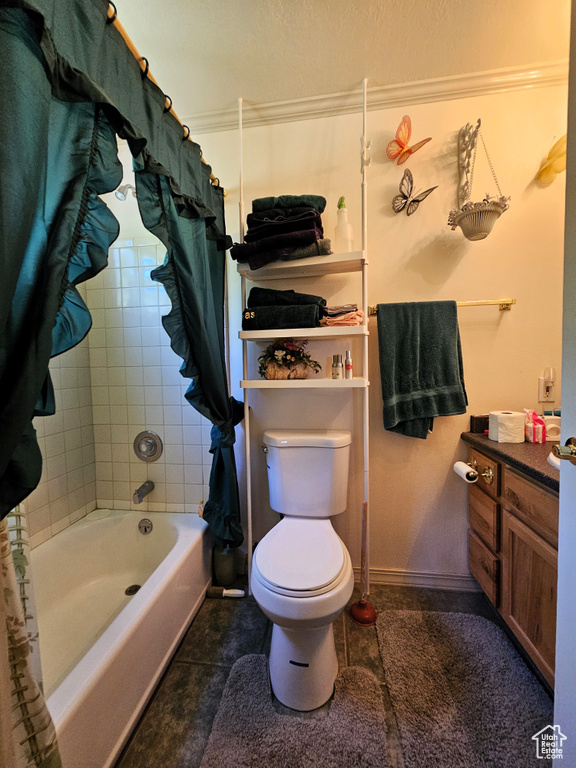 Full bathroom with vanity, ornamental molding, tile floors, shower / bath combination with curtain, and toilet
