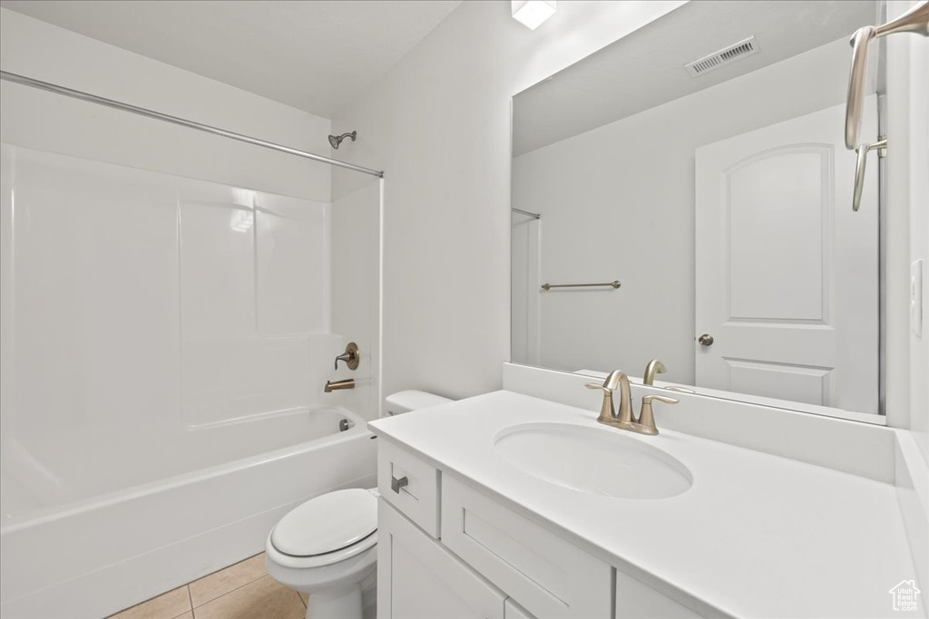 Full bathroom featuring tile floors, oversized vanity, shower / bathing tub combination, and toilet