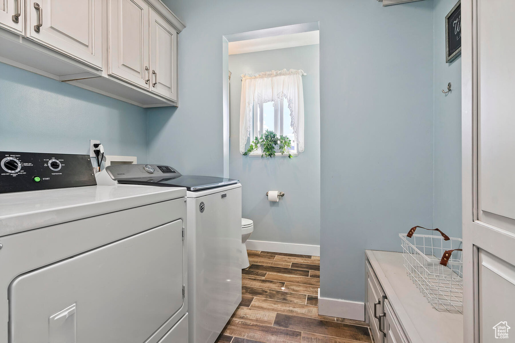 Laundry area featuring washer hookup, washing machine and clothes dryer, and dark hardwood / wood-style floors