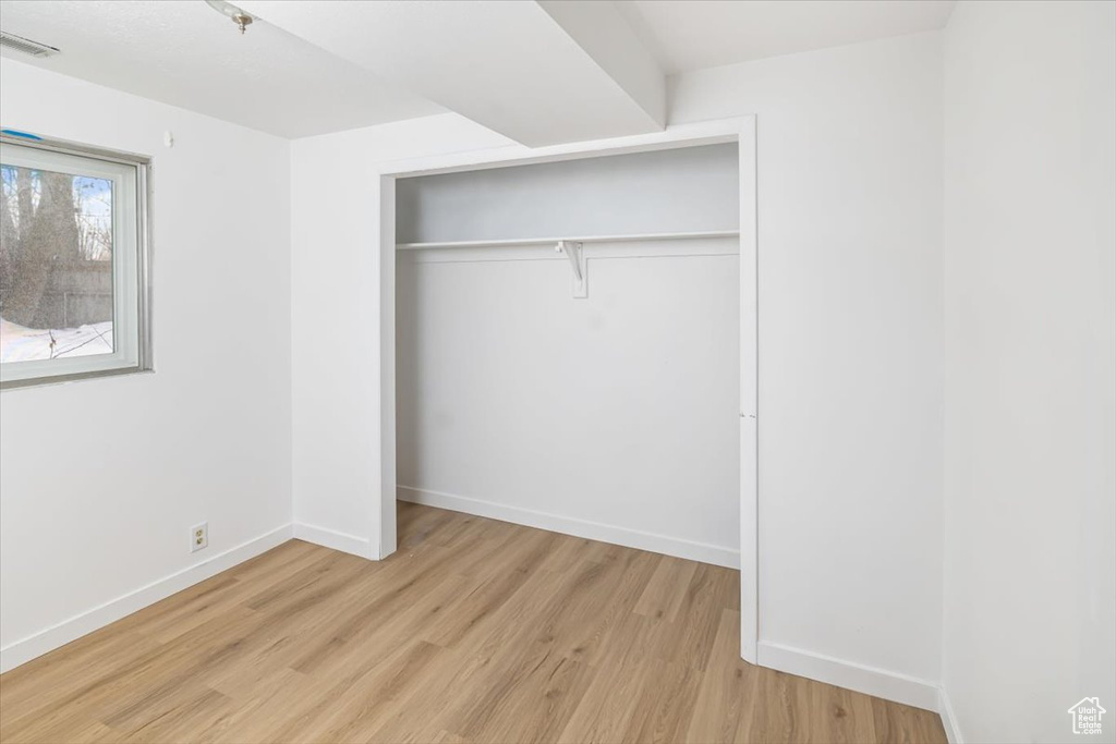 Unfurnished bedroom featuring a closet and light wood-type flooring